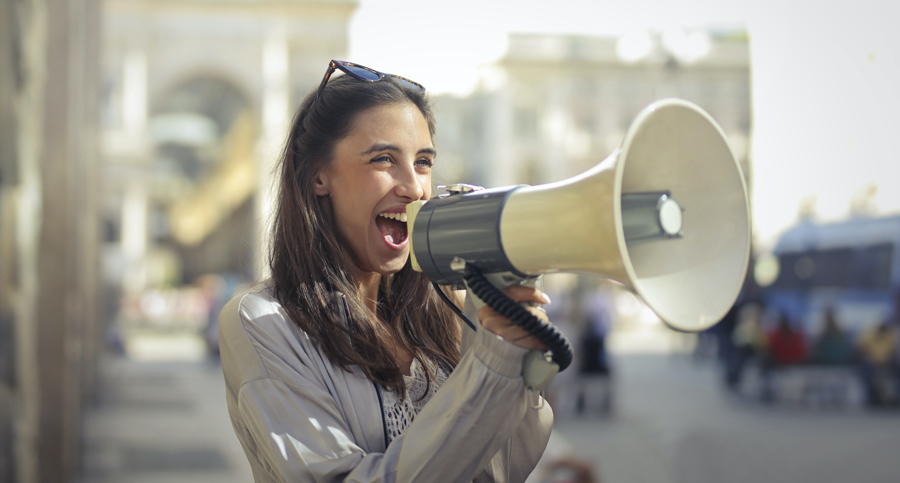 Image of woman shouting into megaphone. Credit Andrea Piaquadio, 2020, Pexels.