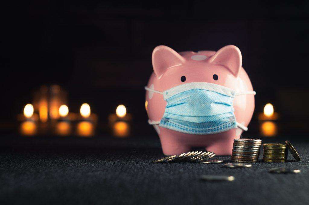 Piggy bank with a mask and coins