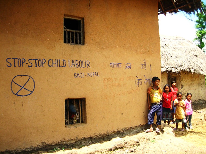 Graffiti on a wall asking to stop child labour.