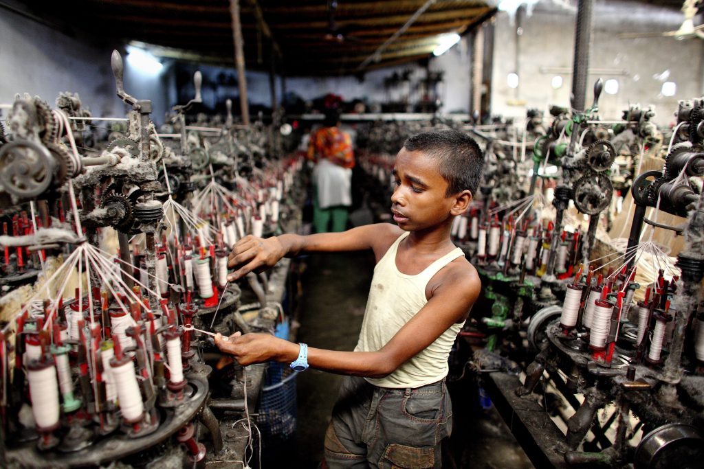 Children labour to make garments.