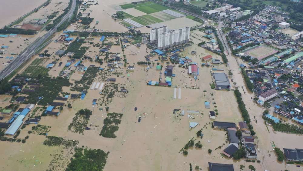 An aerial view shows a village area is flooded due to heavy rain in Gurye, South Korea, Saturday, Aug. 8, 2020.(Chun Jung-in/Yonhap via AP)