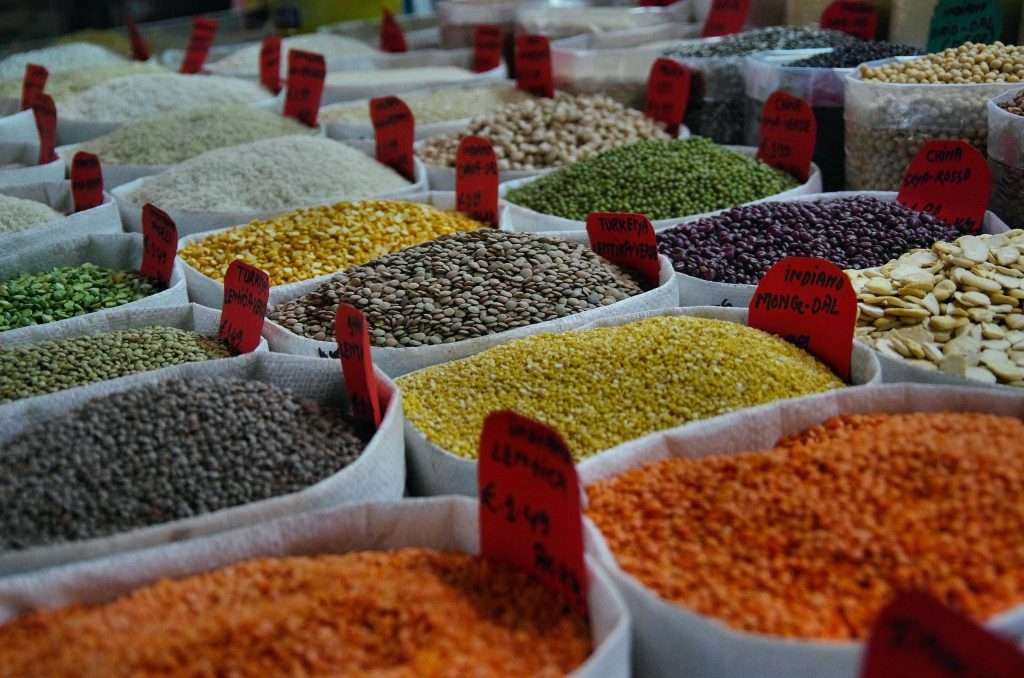 Seeds and grains being sold at a market. 