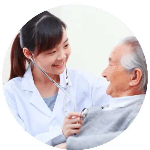 A woman using a stethoscope on an elderly patient. Healthcare is an important facet of thrivable voting.