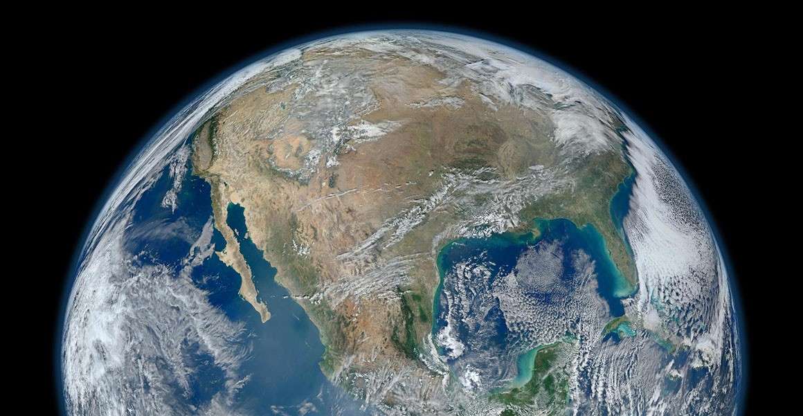 A satellite image of Earth from space. Humans are transforming the planet, creating changes like global warming. But are we impacting the fossil record itself? How does this affect the Anthropocene Epoch?
