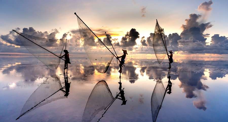 Silhouette of Fishermen with their Fishnets