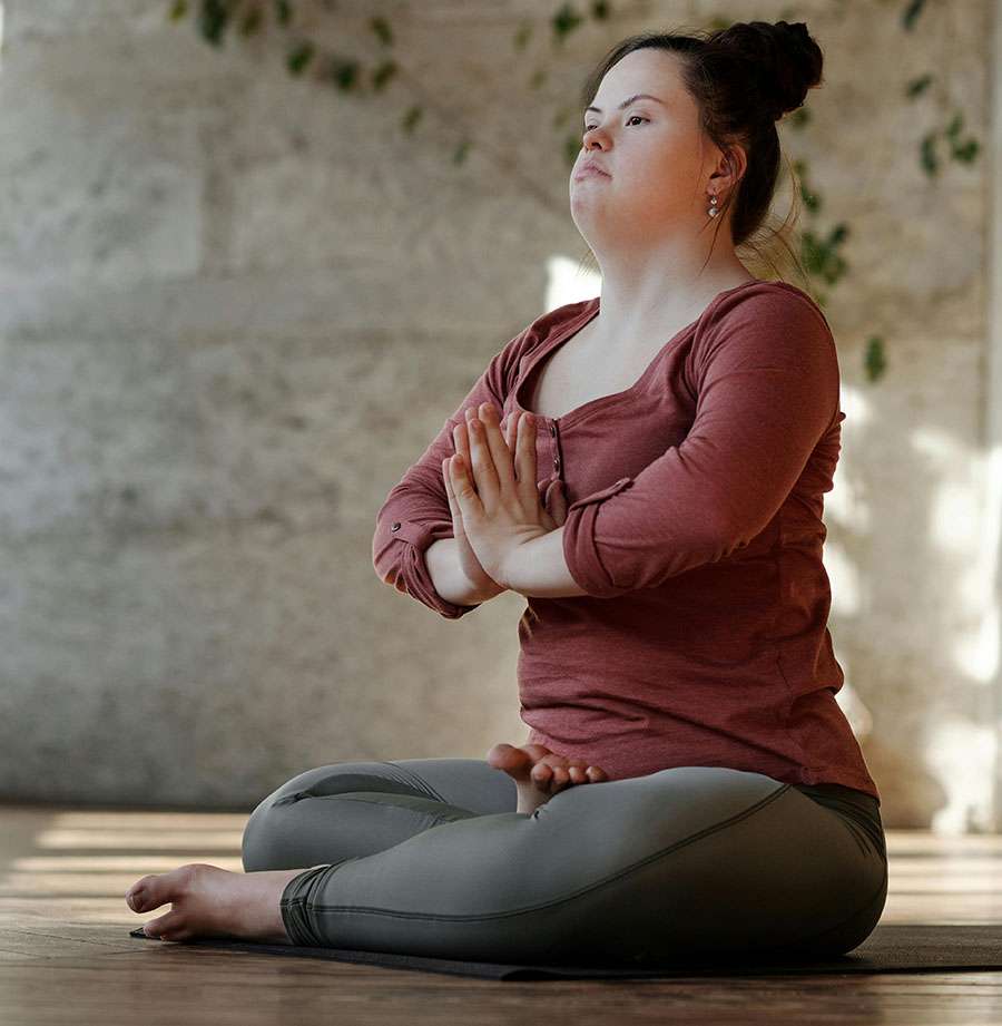 A woman meditating as part of her practices for mental health.